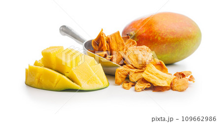 Dried mango fruit in scoop isolated on white background. 109662986