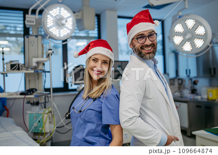 Medical emergency team during Christmas with Santa hat on head. Team of doctors and nurses working a Christmas shift in the hospital, hospital staff can't be with family during Christmas Day and 109664874