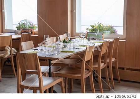 Dining table set with glassware and silverware in restaurant Dining table set with glassware and silverware in restaurant 109666343