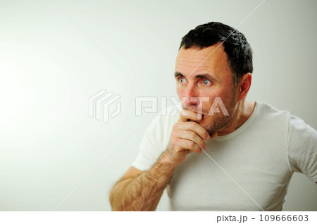 Appalled man emotional guy feeling sinking heart shortness of breath about emotional stress sensations isolated on grey white studio background, frightened person, horror, panic attack concept Appalled man emotional guy feeling sinking heart shortness of breath about emotional stress sensations isolated on grey white studio background, frightened person, horror, panic attack concept 109666603
