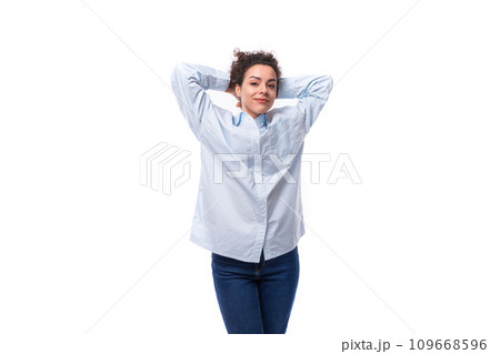 young pretty curly brunette secretary woman in a light blue shirt on a white background with copy 109668596