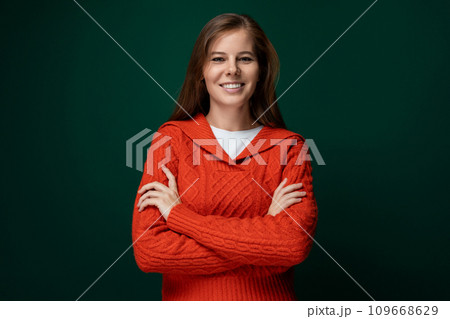 Cute young woman with brown hair wearing a red knitted sweater 109668629