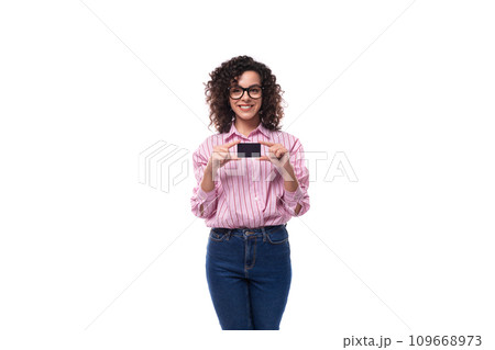 young beautiful curly brunette woman in pink shirt holding plastic card mockup 109668973