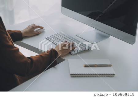 Customer service representative with curly hair talking through headset 109669319