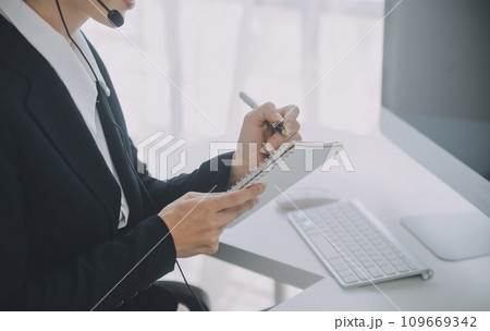 Customer service representative with curly hair talking through headset Customer service representative with curly hair talking through headset 109669342