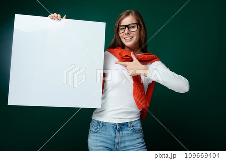 Smart young woman with brown hair showing presentation on whiteboard with mockup 109669404