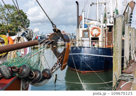 Traditional old german fishing cutter boats moored Neuharlingersiel harbor Wadden sea East Frisia Northern Germany. Commercial fish crab shrimp trawler beam trawl nets North Sea small port city Traditional old german fishing cutter boats moored Neuharlingersiel harbor Wadden sea East Frisia Northern Germany. Commercial fish crab shrimp trawler beam trawl nets North Sea small port city 109670125