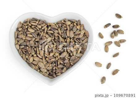 Seeds of a milk thistle or Silybum marianum, Scotch Thistle, Marian thistle in ceramic bowl isolated on white background. Top view. Flat lay 109670891