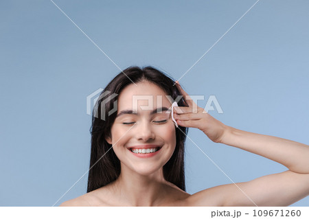 Skin cleaning. Young asian woman standing indoors. High quality photo Skin cleaning. Young asian woman standing indoors. High quality photo 109671260