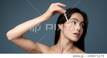 Skin cleaning. Young asian woman standing indoors. High quality photo Skin cleaning. Young asian woman standing indoors. High quality photo 109671279