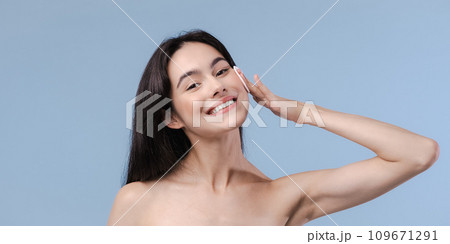 Skin cleaning. Young asian woman standing indoors. High quality photo Skin cleaning. Young asian woman standing indoors. High quality photo 109671291