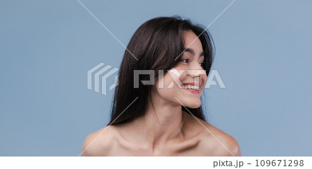 Skin cleaning. Young asian woman standing indoors. High quality photo 109671298