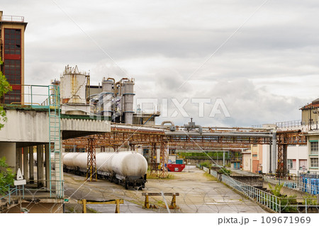 At a chemical plant there are railway tanks with chemicals. 109671969