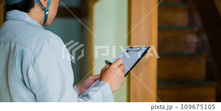 グレーの作業着を着た業者の点検や見積もりシリーズ 109675105