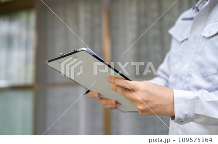 グレーの作業着を着た業者の点検や見積もりシリーズ 109675164