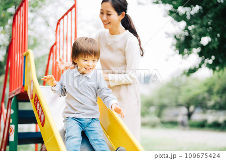 滑り台で遊ぶ親子 109675424