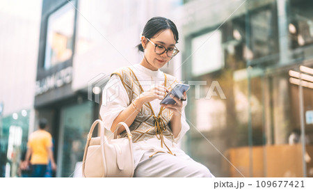 Casual business asian woman using smartphone city lifestyles with modern technology Casual business asian woman using smartphone city lifestyles with modern technology 109677421
