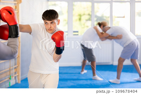 Two men in boxing training perform sparring and one man blocked blow 109678404