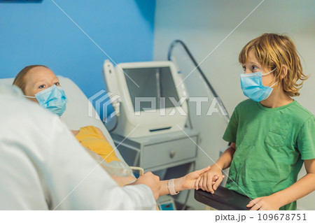 a pregnant mother's ultrasound visit, sharing the excitement with her son who eagerly awaits the arrival of his baby brother. A heartwarming portrayal of family bonds and the anticipation of new 109678751