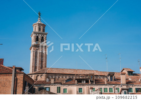 A photograph of a building with a clock tower, taken from an unknown angle and location. No specific landmarks or architectural details are visible. 109682215