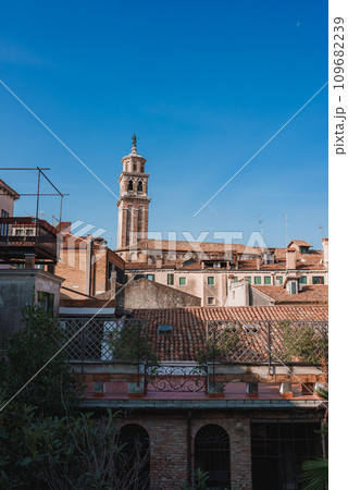 A stunning view of the rooftops of Venice, Italy, with a bell tower in the background. This photo captures the charming atmosphere of the city from a unique perspective. 109682239