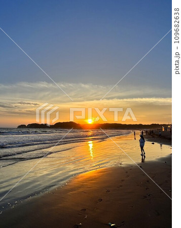 夕暮れの砂浜に佇む男性 109682638