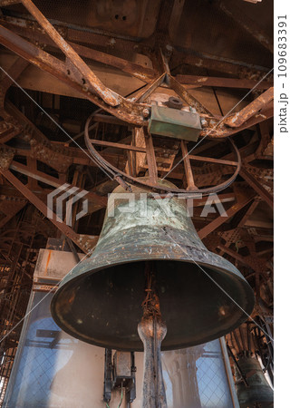 A large bell hangs inside a building in Venice, Italy. The interior is simple with no specific decor. The architectural style and material of the bell are not specified. 109683391