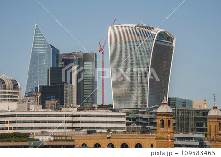 20 Fenchurch street tower amidst buildings. Downtown district in city on sunny day. Modern financial architecture with clear blue sky in background. 20 Fenchurch street tower amidst buildings. Downtown district in city on sunny day. Modern financial architecture with clear blue sky in background. 109683465