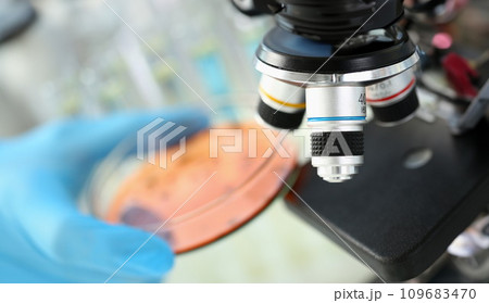 A male chemist holds test tube of glass in his hand A male chemist holds test tube of glass in his hand 109683470