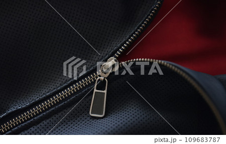 Closeup of zipper on blue leather jacket 109683787
