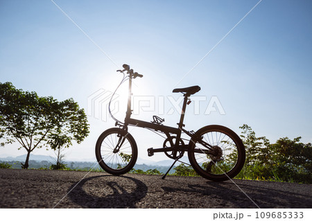 A folding bike on sunrise mountain top road 109685333