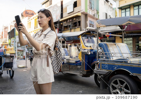 Young Asian woman unhappy with badly functioning smartphone while traveling in city of Bangkok, Thailand Young Asian woman unhappy with badly functioning smartphone while traveling in city of Bangkok, Thailand 109687190