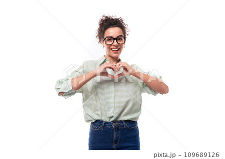 young confident leader woman with curly black hair puts on a shirt and jeans to the office 109689126