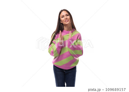 portrait of a well-groomed 35 year old feminine model woman dressed in a pink stylish pullover 109689157