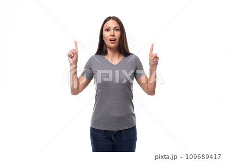 portrait of a charming young european brunette woman in gray clothes on a white background with copy 109689417