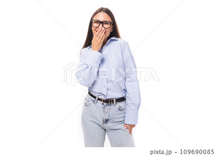 pretty shy young brunette european woman dressed in a blue shirt covered her face with her hand over pretty shy young brunette european woman dressed in a blue shirt covered her face with her hand over 109690085