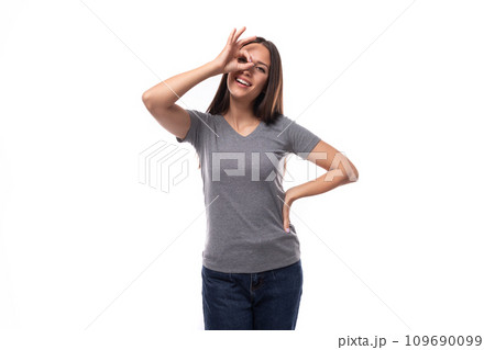 young well-groomed brunette woman in a gray t-shirt with a mock-up for an identity on a white young well-groomed brunette woman in a gray t-shirt with a mock-up for an identity on a white 109690099