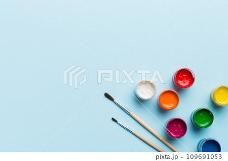 art palette with paint and brushes, close up. Top view with empty space. workplace for creativity. home teaching concept drawing art palette with paint and brushes, close up. Top view with empty space. workplace for creativity. home teaching concept drawing 109691053