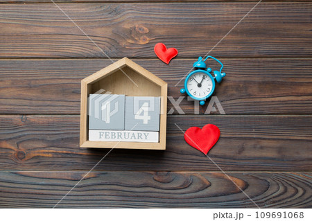 Valentine Day theme with wooden block calendar. Greeting card template for Valentines Day. Top view, copy space for text Valentine Day theme with wooden block calendar. Greeting card template for Valentines Day. Top view, copy space for text 109691068