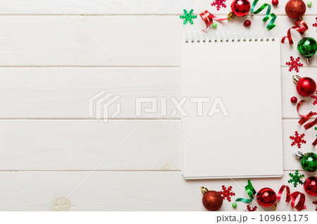 Christmas blank greeting card mock-up scene. Creative layout made of Christmas tree branches and paper card note. Flat lay. Nature New Year concept Christmas blank greeting card mock-up scene. Creative layout made of Christmas tree branches and paper card note. Flat lay. Nature New Year concept 109691175