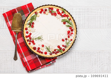 Christmas cake adorned with berries and rosemary 109691411