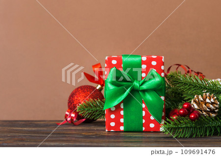 New Year Christmas mood, gift box, branches of a christmas tree, New Year decorations on a colored background 109691476