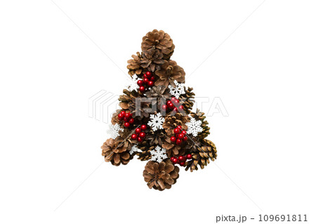 Isolated Christmas tree made from natural cones on colored background, view from above. New Year minimal concept with copy space Isolated Christmas tree made from natural cones on colored background, view from above. New Year minimal concept with copy space 109691811