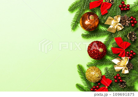 Set of festive balls, fir tree and Christmas decorations on colorful background. Top view of New Year ornament concept with copy space Set of festive balls, fir tree and Christmas decorations on colorful background. Top view of New Year ornament concept with copy space 109691875