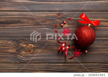 Christmas ball on colored background. decoration bauble with ribbon bow with copy space Christmas ball on colored background. decoration bauble with ribbon bow with copy space 109691981