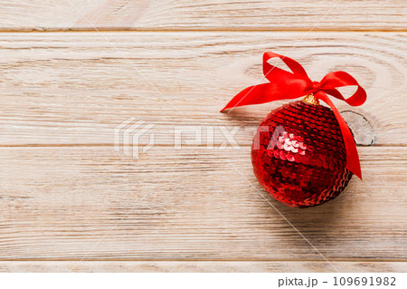 Christmas ball on colored background. decoration bauble with ribbon bow with copy space 109691982