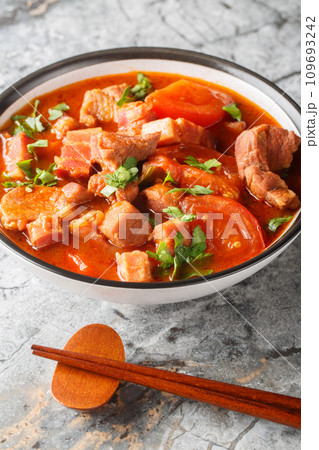 Chinese Indonesian Babi Tomat pork stewed tomato closeup in a bowl. Vertical Chinese Indonesian Babi Tomat pork stewed tomato closeup in a bowl. Vertical 109693242