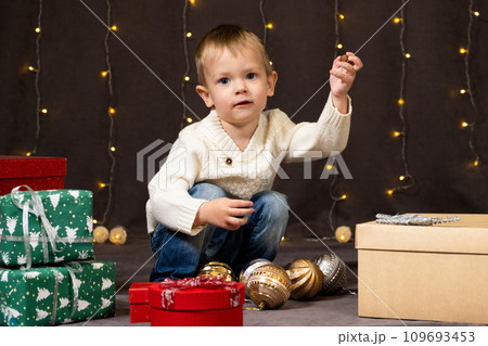 Portrait of happy little child playing with Christmas toys. 109693453