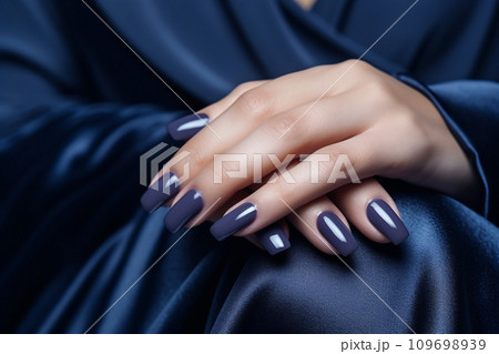 Glamour woman hand with navy blue nail polish on her fingernails. Navy nail manicure with gel polish at luxury beauty salon. Nail art and design. Female hand model. French manicure. Generative AI. 109698939