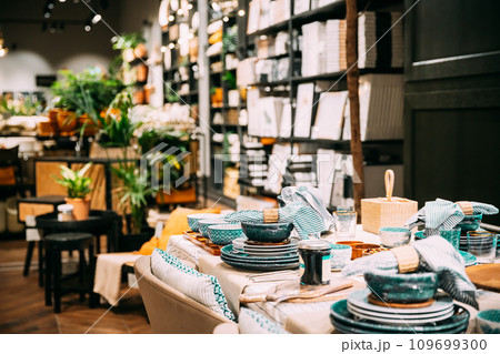View of assortment of decor for interior shop in store of shopping center. Home accessories and household products for dining room in store of shopping centre. Home accessories of dinnerware on table 109699300